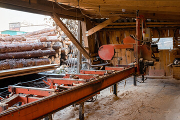 Naklejka premium Woodworking sawmill. Old sawmill equipment. Timber industry