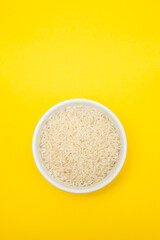 raw rice on white bowl on gray ceramic