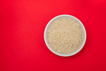 raw rice on white bowl on gray ceramic