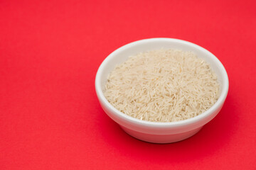 raw rice on white bowl on gray ceramic