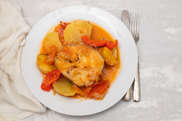 typical portuguese fish stew on white plate