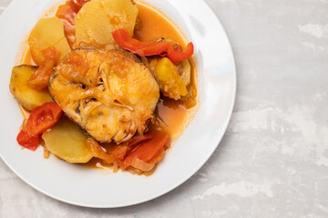 typical portuguese fish stew on white plate