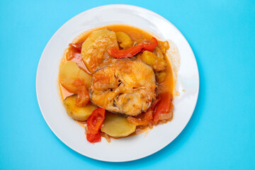 typical portuguese fish stew on white plate
