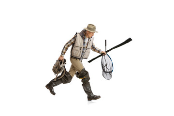 Portrait of young man, professional fisherman with fishing rod, spinning and equipment going to river isolated over white studio background