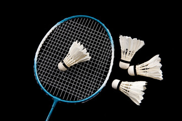 Badminton shuttlecock and badminton racket on black background