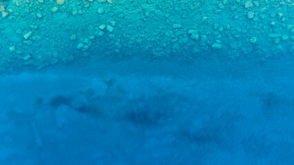 Background image of the turquoise sea. Deep sea and corals. Top view of beautiful  Sea. Aerial drone shot of turquoise water. Aquamarine background..