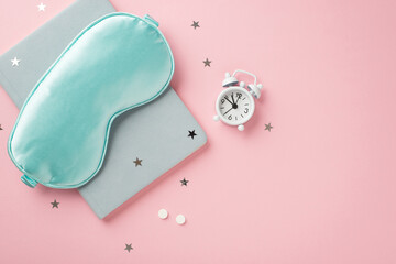 Top view photo of blue silk sleeping mask small white alarm clock pills blue reminder and star...
