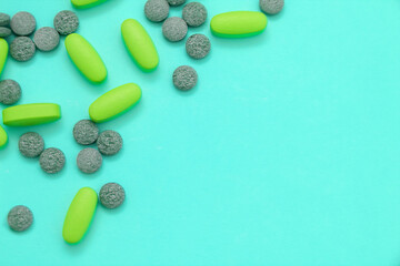 Frame of pills and capsules spilling on blue background. Medicine concept of pain, depression, treatment.