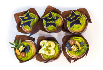 Set of sweet creative cupcakes with decor for 23 february holiday isolated on white background.