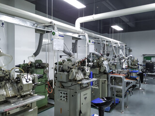 A series of lathes for watchmaking at a factory in China. Production of parts at the production site. Workshop