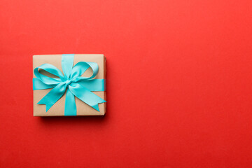 Holiday present box over colored background, top view. Copy space for design