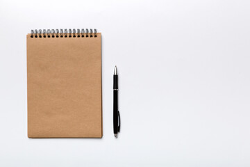 school brown notebook on a colored background, spiral craft notepad on a table Top view