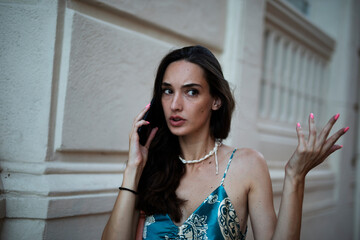 Beautiful young elegance woman using the phone. Beautiful fashion woman talking to the phone..