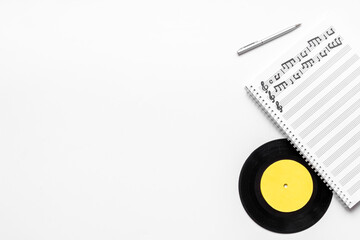 Sheets with music notes and vinyl record. Compose music concept