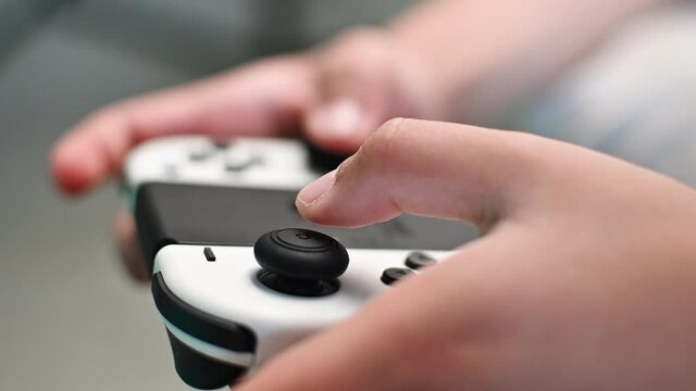 Boy playing video game using joystick, close up