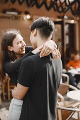 Two lovers hug on the streets of the old city during a date