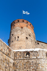 Obraz premium Olavinlinna is under blue sky, vertical photo