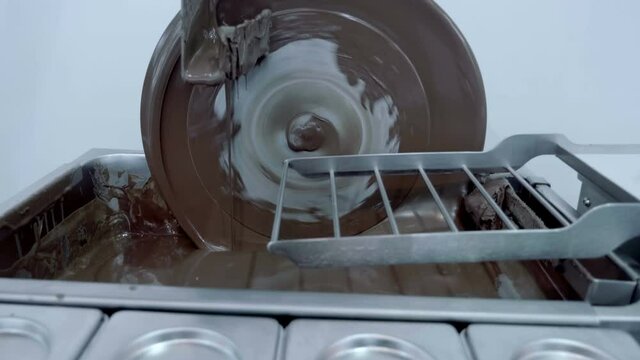 Industrial equipment for making chocolate. Grated cocoa is subjected to long-term continuous intensive stirring at a temperature of 55 to 90 &deg; C. Shot in motion. Closeup