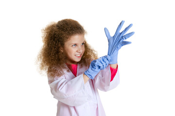 Half-length portrait of cute beautiful little girl, child in image of dentist doctor wearing white lab coat and gloves isolated on white studio background