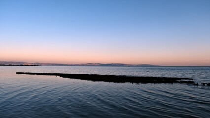 Fototapeta na wymiar Sea view with mountains at dawn and sunrise