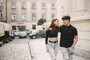 Two lovers hug on the streets of the old city during a date