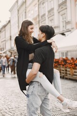 Two lovers hug on the streets of the old city during a date