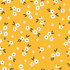 Beautiful vintage pattern. Small white flowers, black leaves. Yellow background. Floral seamless background. An elegant template for fashionable prints.