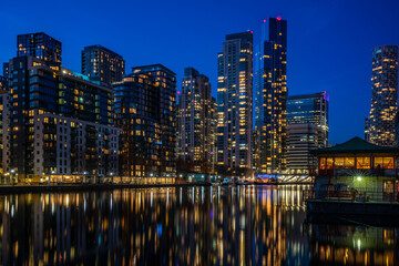 Evening view of Millwall Inner Dock with reflections in water, London UK