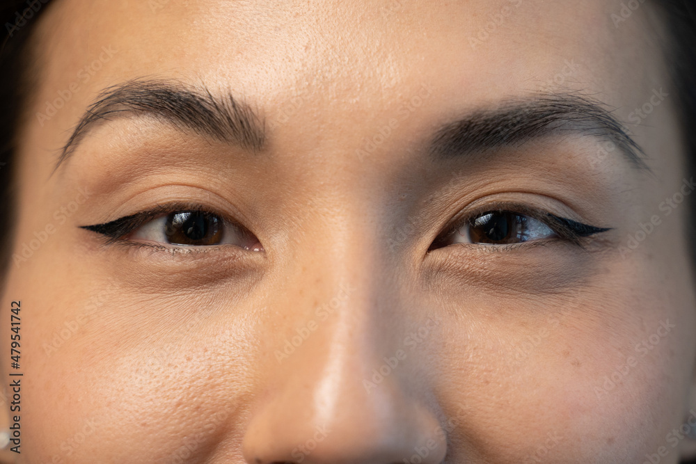 Wall mural close up of beautiful young asian woman with brown eyes