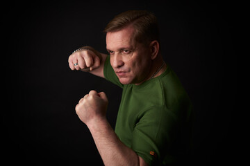 Studio portrait of a middle aged handsome male in green t-shirt