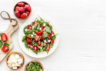 Vegetarian lunch spinach and strawberry salad. Top view