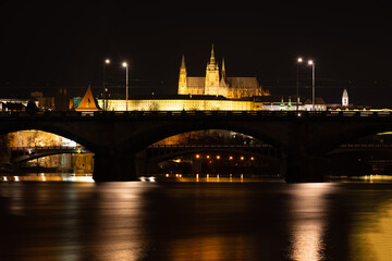 Fototapeta premium Prague at night, view of bridges on the Vlatava river, reflection of night city lights, cityscape
