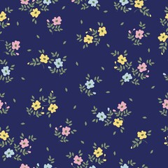 Beautiful vintage pattern. Small pink, blue and yellow flowers, green leaves. Blue background. Floral seamless background. An elegant template for fashionable prints.