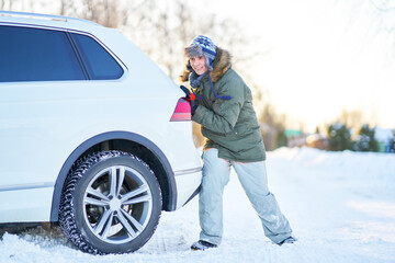 Fototapeta Man having problem with car during snowy winter obraz