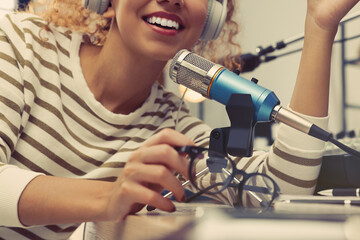 African American woman working as radio host in modern studio, closeup