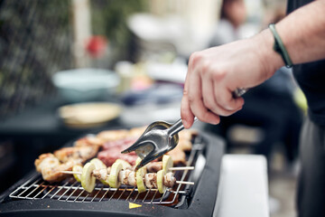 Preparing barbeque on a electrical modern grill outdoors.
