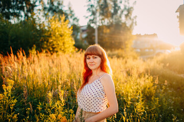 portrait of red hair girl on summer background