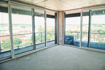 Empty unfinished room on construction site at daytime. Conception of business