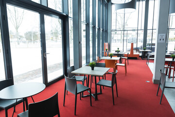 interior of a cafe colorful chairs seats plants on tables design