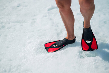 Woman in flippers in the snow. Close-up of the female feet. © Михаил Решетников