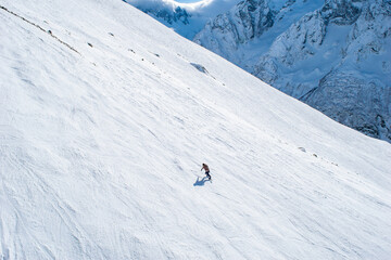A skier going down the mountainside