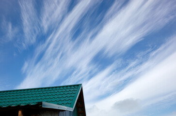 Construction of the roof of the house. Metal tiles against blue sky