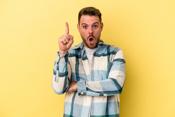 Young caucasian man isolated on yellow background having some great idea, concept of creativity.