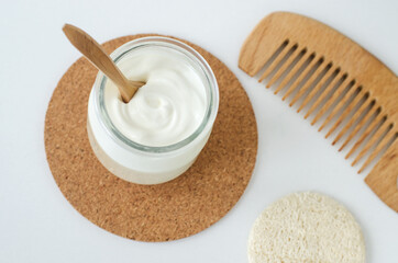 Homemade greek yogurt facial mask in a glass jar. Diy natural beauty treatment recipe. Top view, copy space.