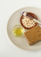 Coffee bar of soap, olive oil, oatmeal,  and make-up brush. Natural beauty treatment and zero waste concept. Top view, copy space.