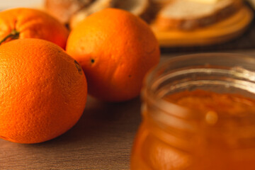 Natural oranges to make jam with rustic breads in the background
