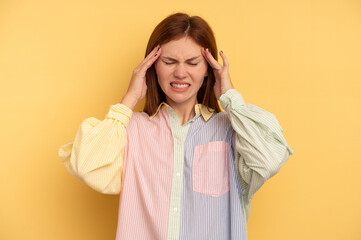 Young English woman isolated on yellow background touching temples and having headache.