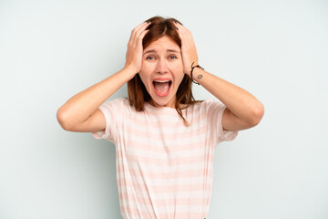 Young English woman isolated on blue background screaming, very excited, passionate, satisfied with something.