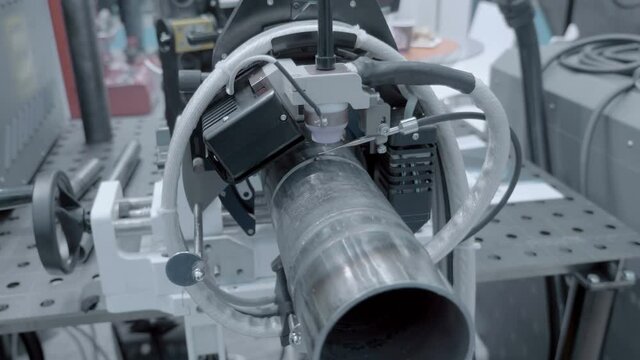 Industrial equipment for automatic welding of metal pipes. Shot in motion. Closeup
