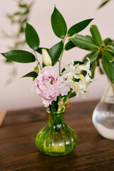 Pink eustoma and white hyacinth flowers in a glass vase in the decor of the house